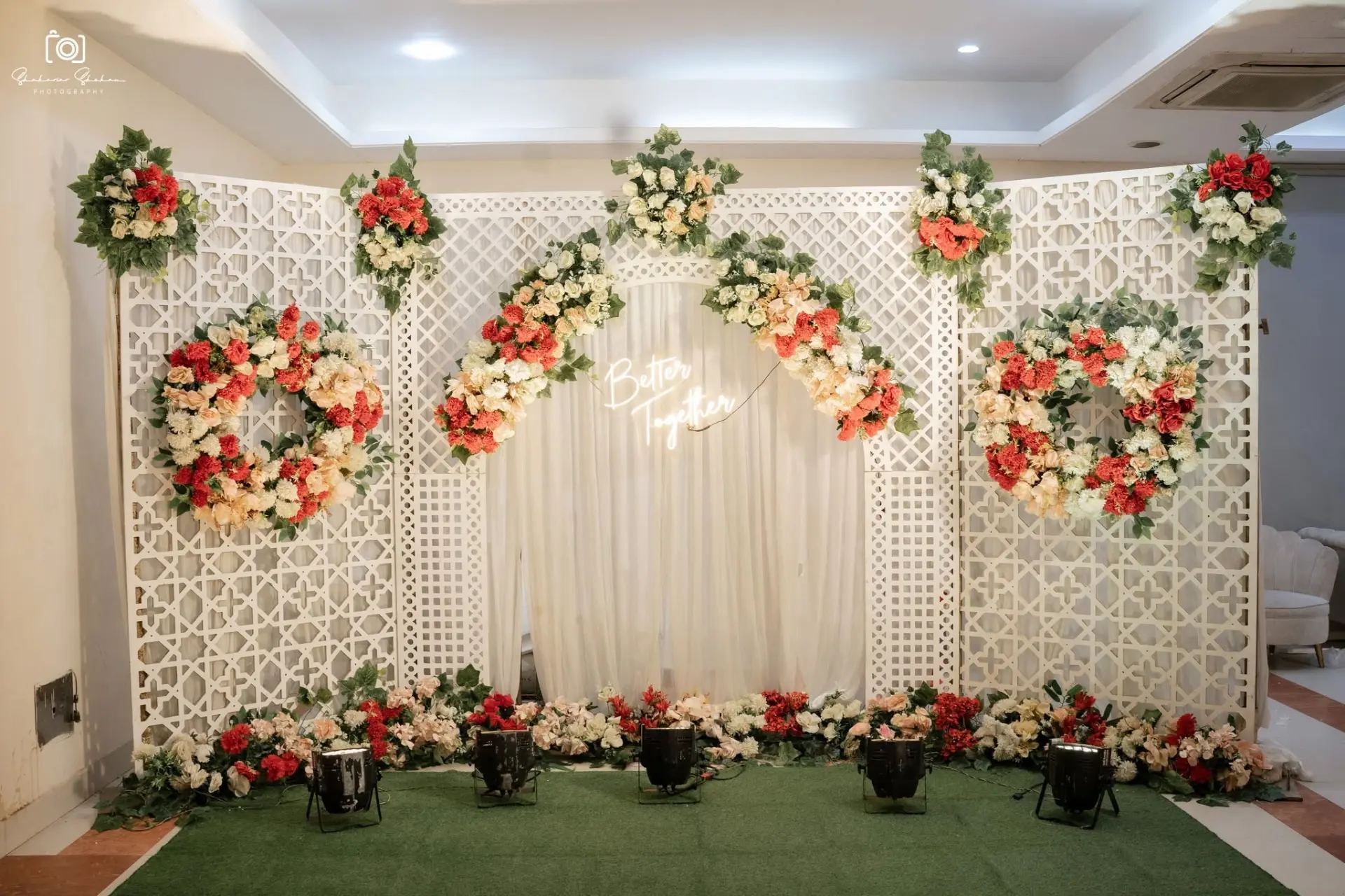 Better Together neon photo backdrop with floral wreaths