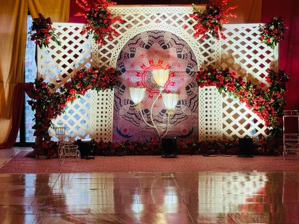 Red floral lattice backdrop with mandala motif