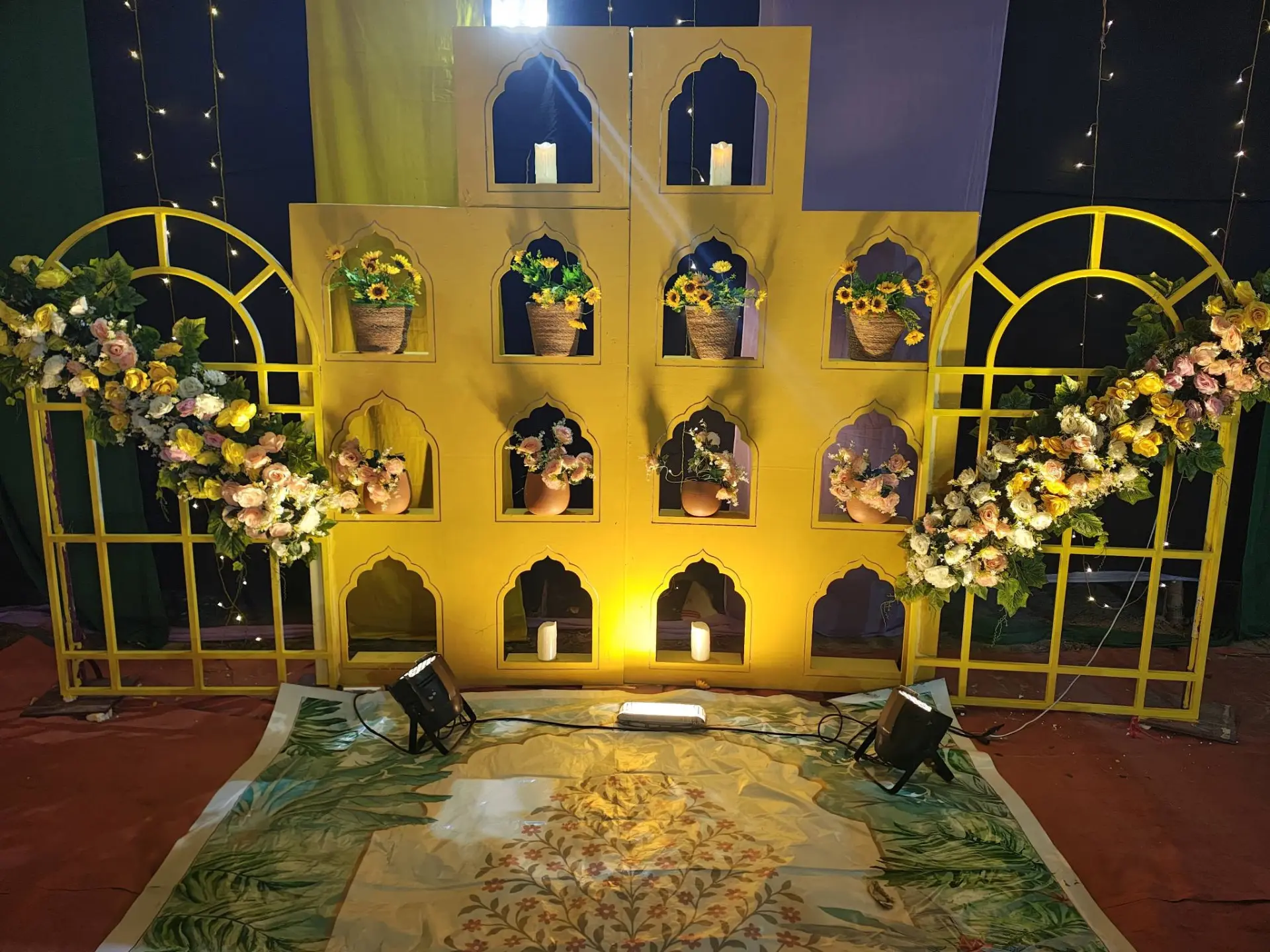 Yellow arched backdrop with sunflowers and candles