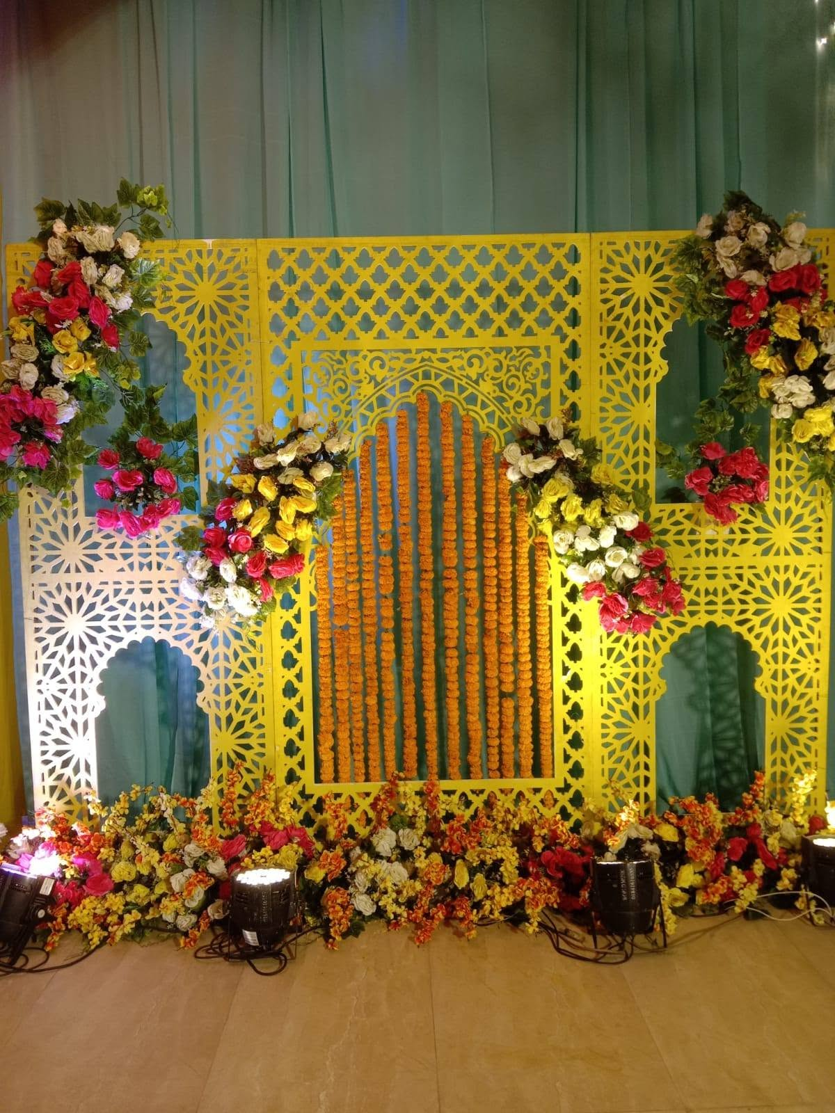 Yellow panel backdrop with marigold strings