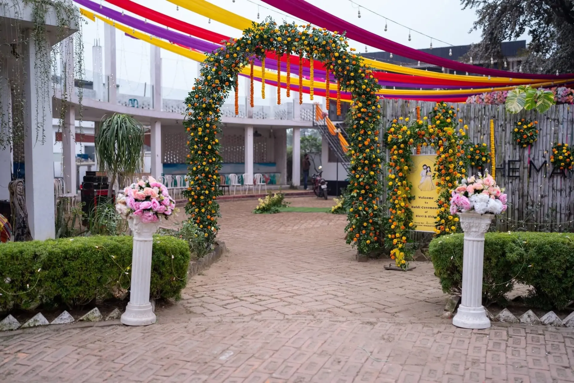 Marigold entrance arch with colourful overhead drapes