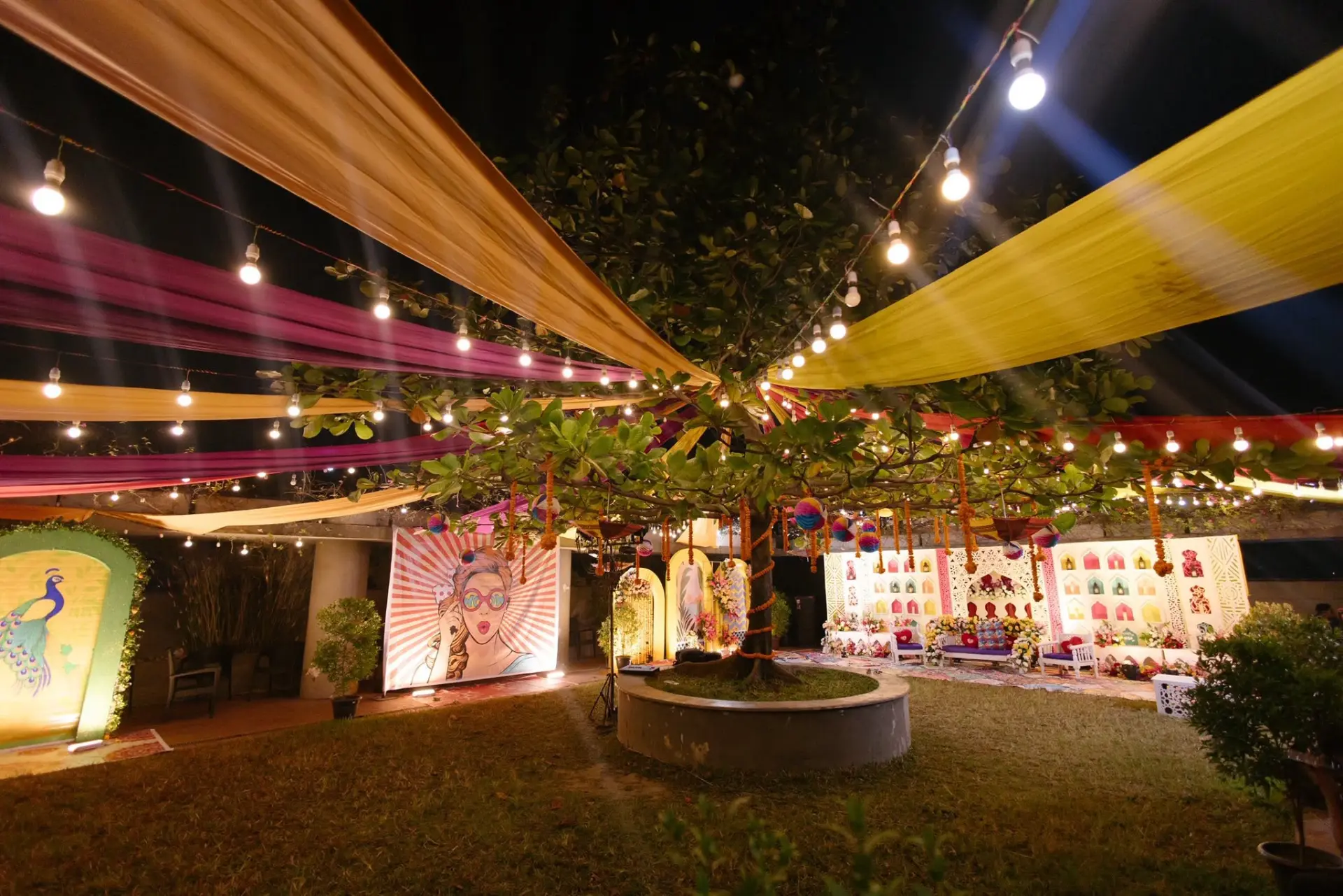 Night view of the garden with fairy lights and draped canopy
