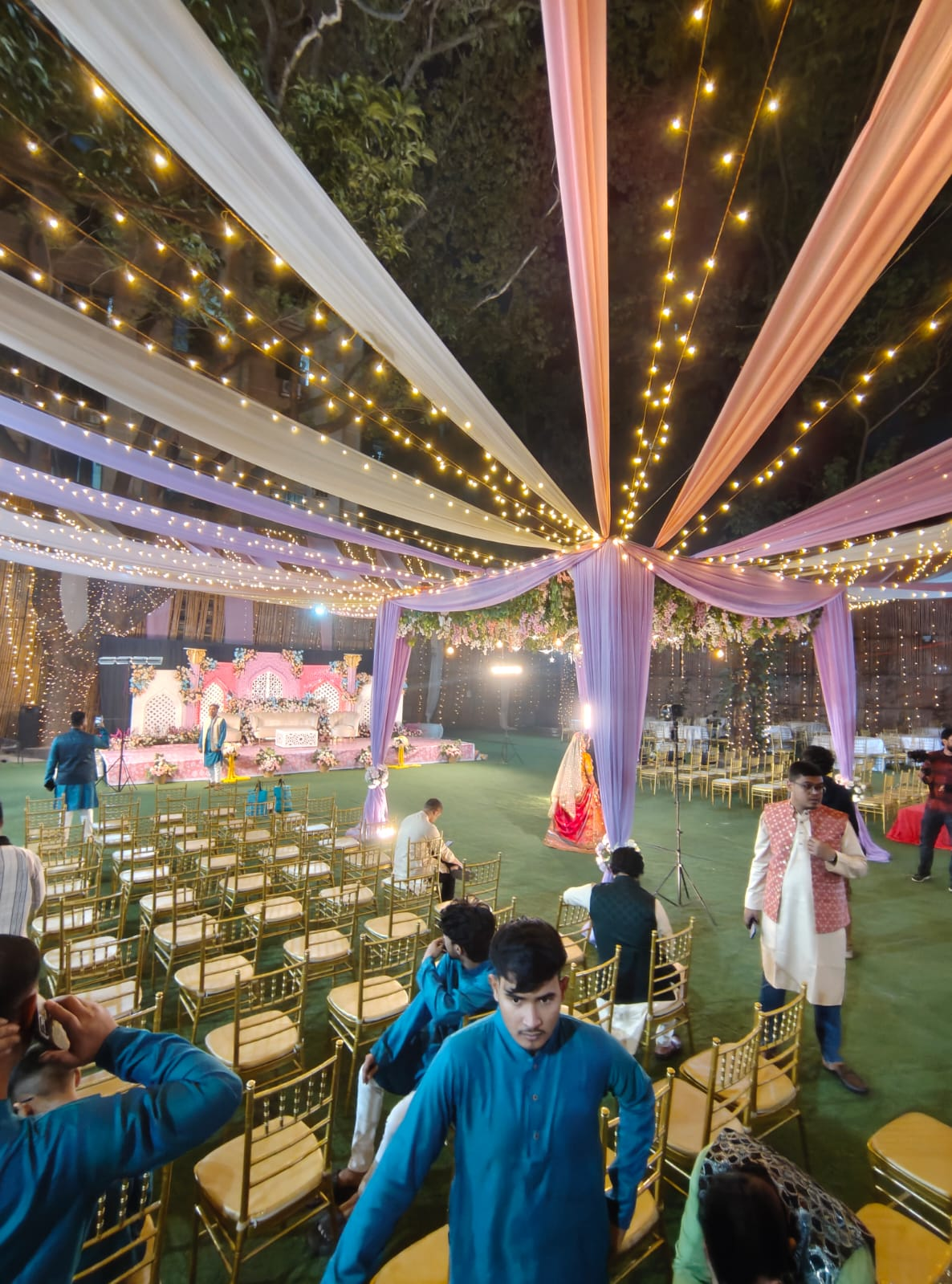 Fairy-light draped outdoor haldi venue