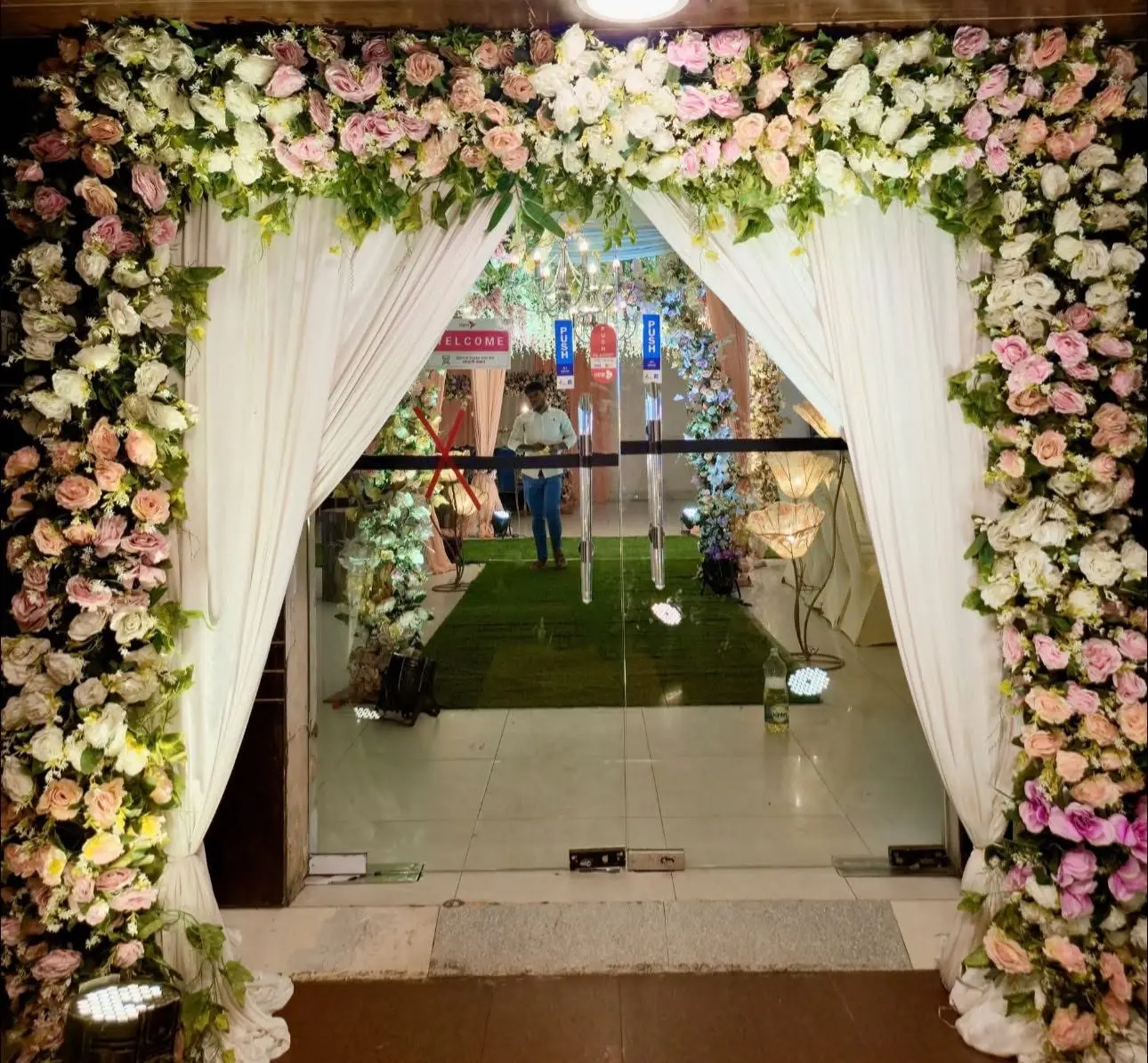 Floral entrance gate with white drapes