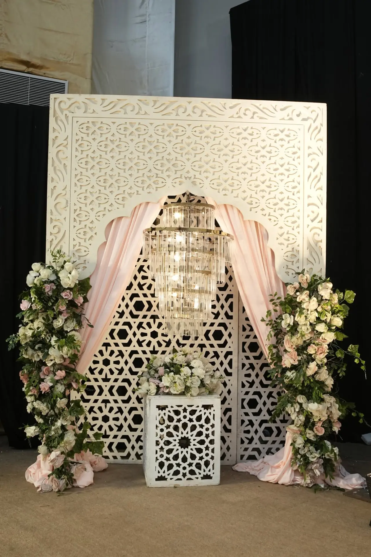 Ornate jharokha panel with crystal chandelier and florals