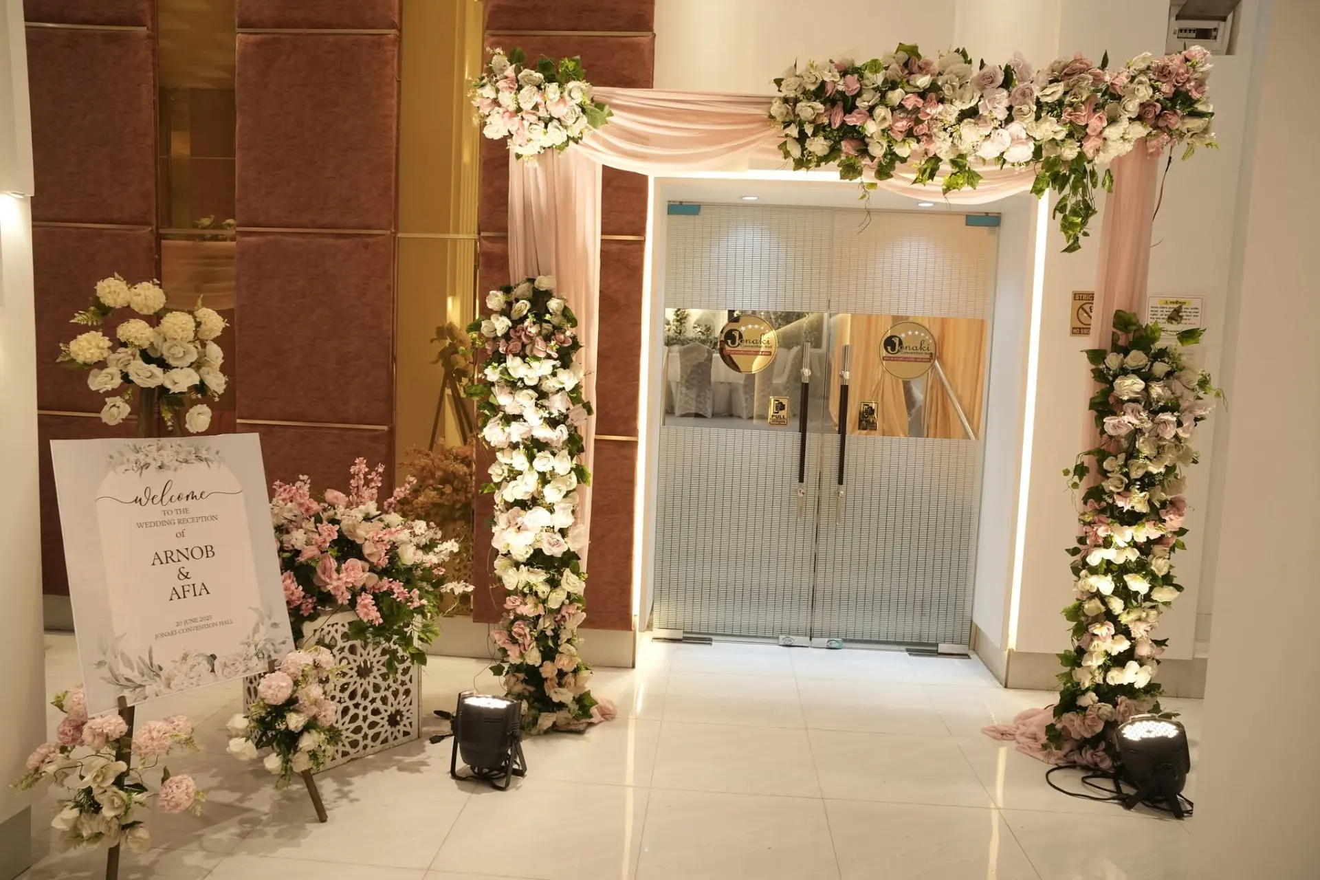Floral entrance arch with welcome sign