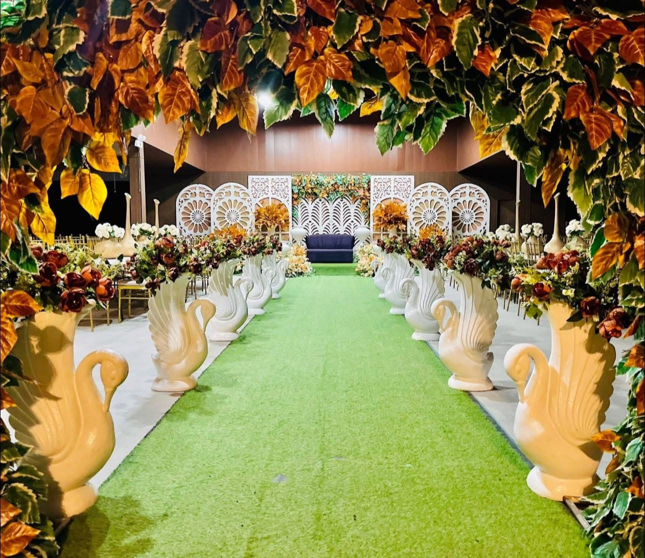 Swan urn aisle under golden autumn leaf canopy